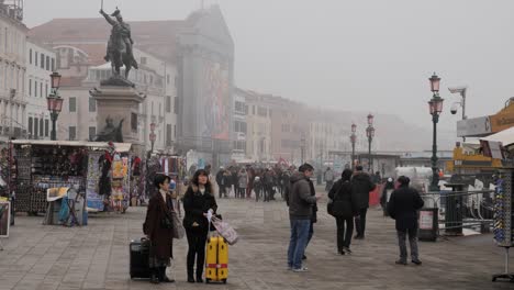 Tourists-And-Vendors-Near-Boat-Dock-In-Promenade-In-Venice-Near-St-Mark's-Square-After-The-Cancelled-Carnival