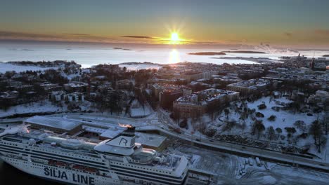 Aerial-view-overlooking-traffic-on-road-E75,-winter-evening-in-Helsinki,-Finland---tracking,-drone-shot
