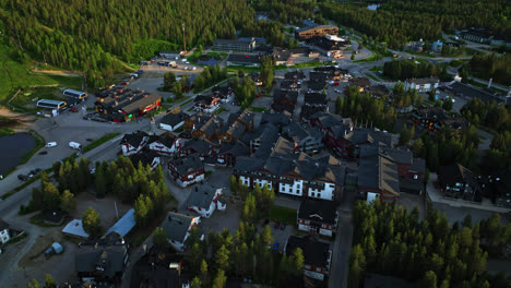 Aerial-view-around-hotels-and-stores-in-the-Levi-town,-summer-evening-in-Lapland,-Finland---orbit,-drone-shot