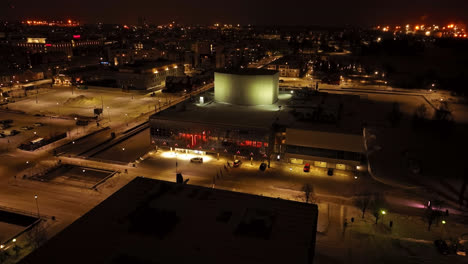 Aerial-view-tilting-toward-the-Oulu-Theatre,-winter-evening-in-North-Ostrobothnia,-Finland