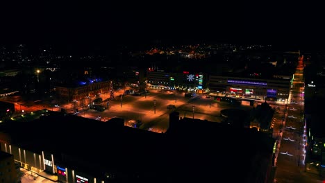 Aerial-view-overlooking-the-market-square-and-Kuopio-City-Hall,-winter-night-in-Savo,-Finland---circling,-drone-shot
