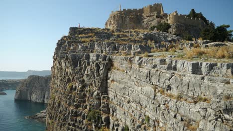 Cliffs-and-the-Lindos-Acropolis-on-top-of-the-hill-from-low-angle