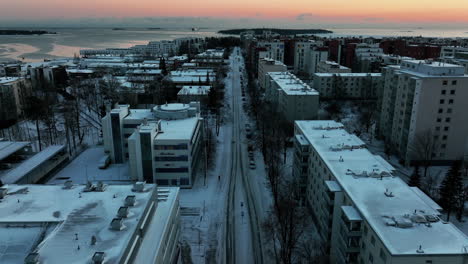 Aerial-view-over-frozen-streets-in-Lauttasaari,-winter-evening-in-Helsinki,-Finland