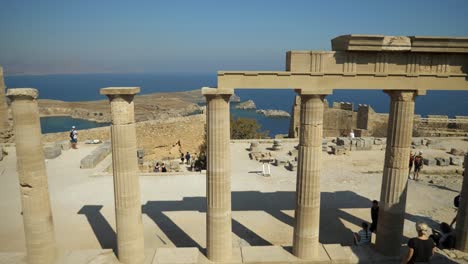 Columns-of-the-old-Lindos-Acropolis,-Coast-and-Mediterranean-Sea-in-background