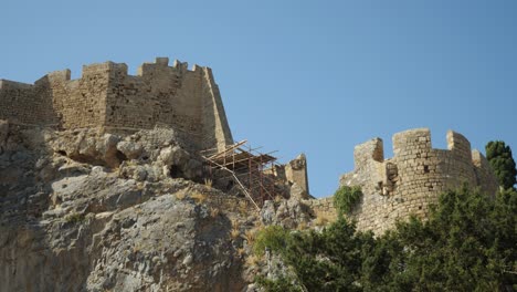 Close-up,-low-angle-shot-of-the-walls-of-Lindos-Acropolis-on-the-cliffs