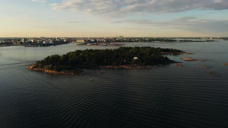 Aerial-view-around-the-Pihalajasaari-island-with-Helsinki-cityscape-in-the-background---circling,-drone-shot