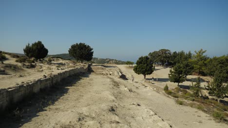 People-walking-among-the-ruins-of-the-ancient-Acropolis-of-Kamiros,-Rhodes-Island