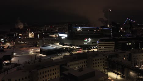 Aerial-view-around-the-Nokia-arena,-winter-night-in-Tampere,-Finland---circling,-drone-shot