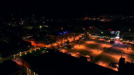 Aerial-view-around-the-illuminated-Kuopio-City-Hall,-winter-evening-in-Savo,-Finland---orbit,-drone-shot