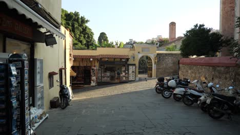 Streetview-of-Rodos-Town,-Gift-shops-and-parking-motorbikes