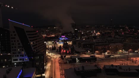 Aerial-view-of-the-Ratina-district-of-Tampere,-winter-night-in-Finland---tracking,-drone-shot