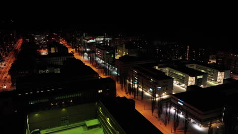 Aerial-view-overlooking-quiet-streets-of-Lauttasaari,-winter-evening-in-Helsinki,-Finland---circling,-drone-shot