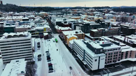 Aerial-view-around-the-Asemakatu-street,-in-snowy-Jyvaskyla,-Finland---circling,-drone-shot