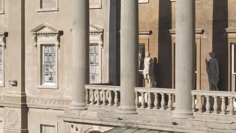 Close-up-aerial-of-the-atrium-and-balcony-of-the-mansion-along-with-its-haunting-statues