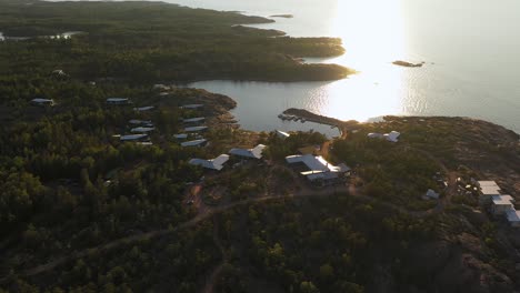 Aerial-view-overlooking-the-Havsvidden-resort,-summer-sunset-in-Ahvenanmaa,-Finland---orbit,-drone-shot