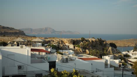 Blick-Auf-Die-Weißen-Häuser-Von-Lindos-Mit-Dem-Mittelmeer-Und-Den-Hügeln-Im-Hintergrund