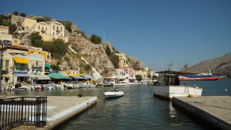 View-of-the-colorful-Ano-Symi-harbour-with-boats-and-a-ferry
