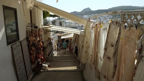 People-in-a-narrow-street-of-Lindos,-Part-four