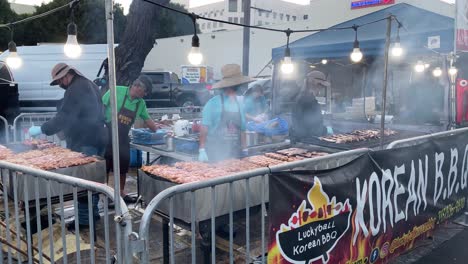 Korean-BBQ-stand-outdoor-cooking-at-the-Santa-Monica-night-market,-in-Los-Angeles---static-view