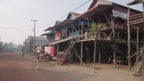 Street-in-Kampong-Phluk-Cambodia,-houses-on-stilt-traveling