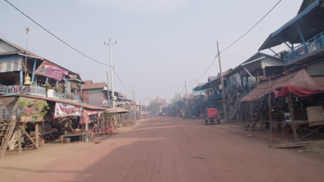 Driving-down-Street-in-Kampong-Phluk-with-houses-on-stilt