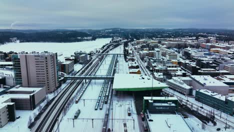 Aerial-view-towards-the-railway-station-in-Jyvaskyla,-winter-evening-in-Finland