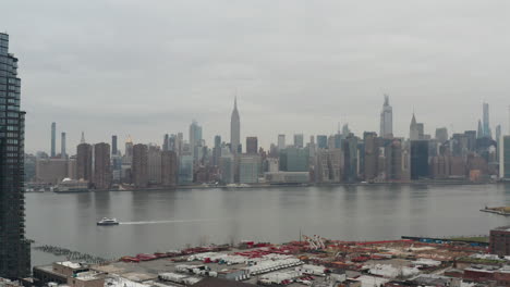 Slow-Pan-on-NYC-midtown-Skyline-and-empire-State-building-from-industrial-zone-on-a-cloudy-day-neutral-color-correction