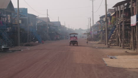 Street-in-Kampong-Phluk-Cambodia-at-sunrise,-houses-on-stilt