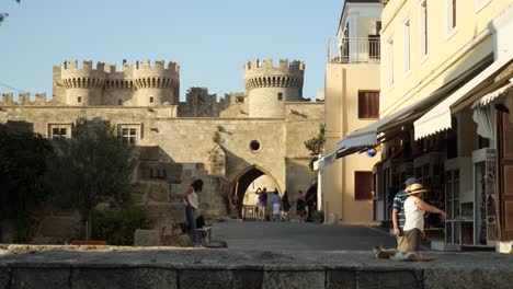 Streetview-of-the-Old-Town-of-Rhodes-with-the-Palace-of-the-Grand-Master-of-the-Knights-in-background-at-golden-hour