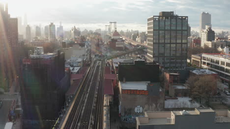 Fly-over-elevated-subway-Track-with-Williamsburg-Bridge-in-background