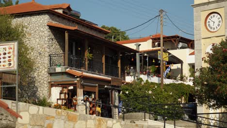 Low-angle-view-of-houses-with-shop-and-restaurant-in-the-quiet-village,-Siana