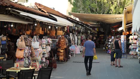 Bag,-clothes-and-souvenir-shops-in-the-street-of-the-Old-Town-of-Rhodes