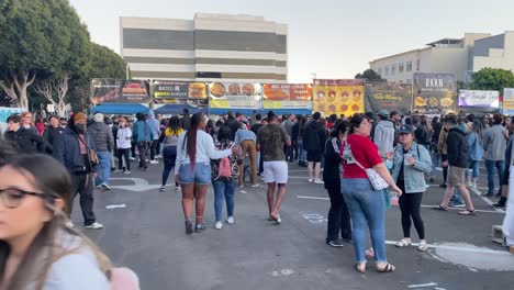 A-large-crowd-of-people-enjoying-Asian-food-at-the-626-Santa-Monica-night-market-mini,-in-Los-Angeles---static-view