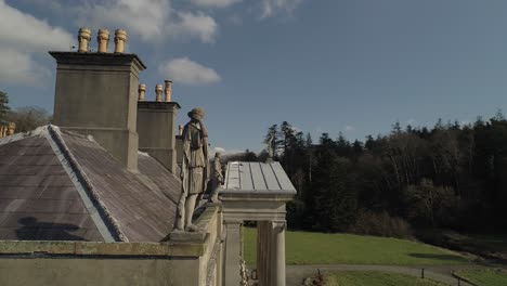 Aerial-rotating-around-the-roof-and-statues-mounted-on-the-Glynliffon-estate