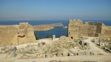 View-on-the-coast-through-the-Acropolis-walls-in-Lindos,-No-people