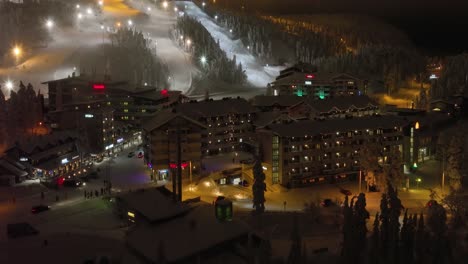 Aerial-view-of-traffic-and-people-in-the-Ruka-ski-village,-in-Kuusamo,-Finland---circling,-drone-shot