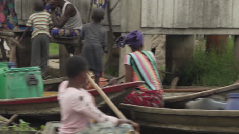 Kids-filling-up-water-tanks-while-on-Canoe-in-Ganvie-Bening