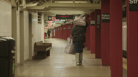 Homeless-man-carrying-his-belonging-in-NYC-Fulton-Street-subway-station-during-covid-19
