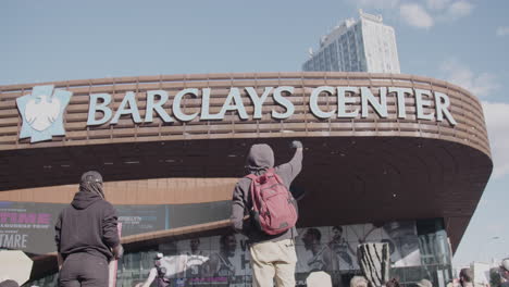 Protester-holding-his-fist-up-in-front-of-Barclays-Center-during-BLM-protest-in-slomo