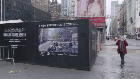 Men-putting-Face-Mask-in-front-of-ironic-new-Madison-Square-Garden-sign-A-New-Experience-is-coming
