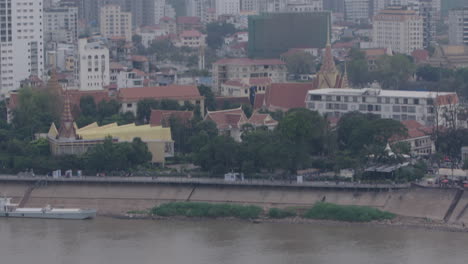 Tilt-up-from-maritime-traffic-on-Tonle-Sap-to-Phnom-Penh-City