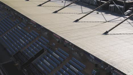 Tracking-aerial-closeup-along-the-length-of-the-main-stand-at-Sandy-Park,-home-of-the-Exeter-Chiefs