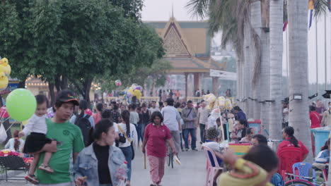 Popular-and-busy-riverside-park-with-young-Khmers-in-Phnom-Penh-tilt-down