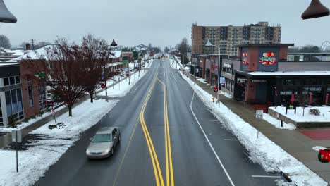 Aerial-flyover-of-suburban-street-in-winter