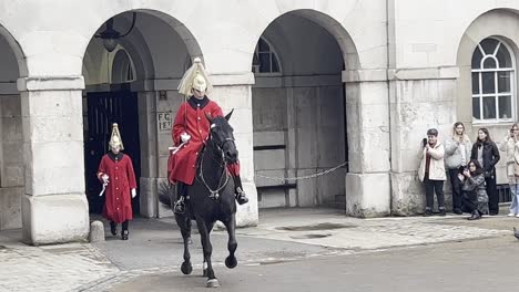 Tourist-look-on-as-the-Kings-royal-Horse-guard-perform-daily-change-of-guard-ceremony