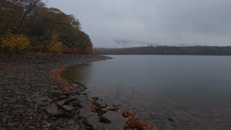 Atmospheric-rainy-autumn-day-on-a-pristine,-rocky,-mountain-lake-shore-60FPS