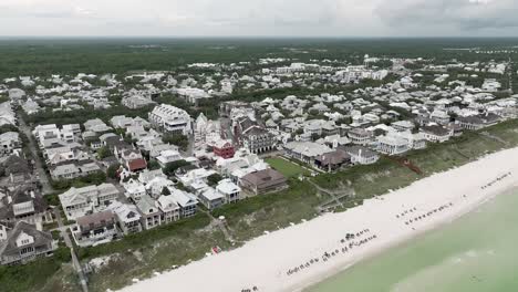 Wide-full-view-slow-spin-motion-of-Rosemary-Beach-Town,-Western-Green-with-beach-front