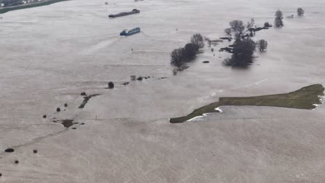 Aerial-of-rainfall-and-high-water-level-along-the-Waal-River-in-Varik,-Gelderland,-Netherlands