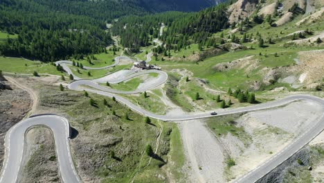 Scenic-Road-Col-Izoard-Mountain-Pass-in-French-Alps,-France---Aerial-4k-Reveal-Tilting-Up