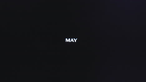 Blue-static-spreads-vertical-lines-up-across-capital-letters-of-May-in-sans-serif-font